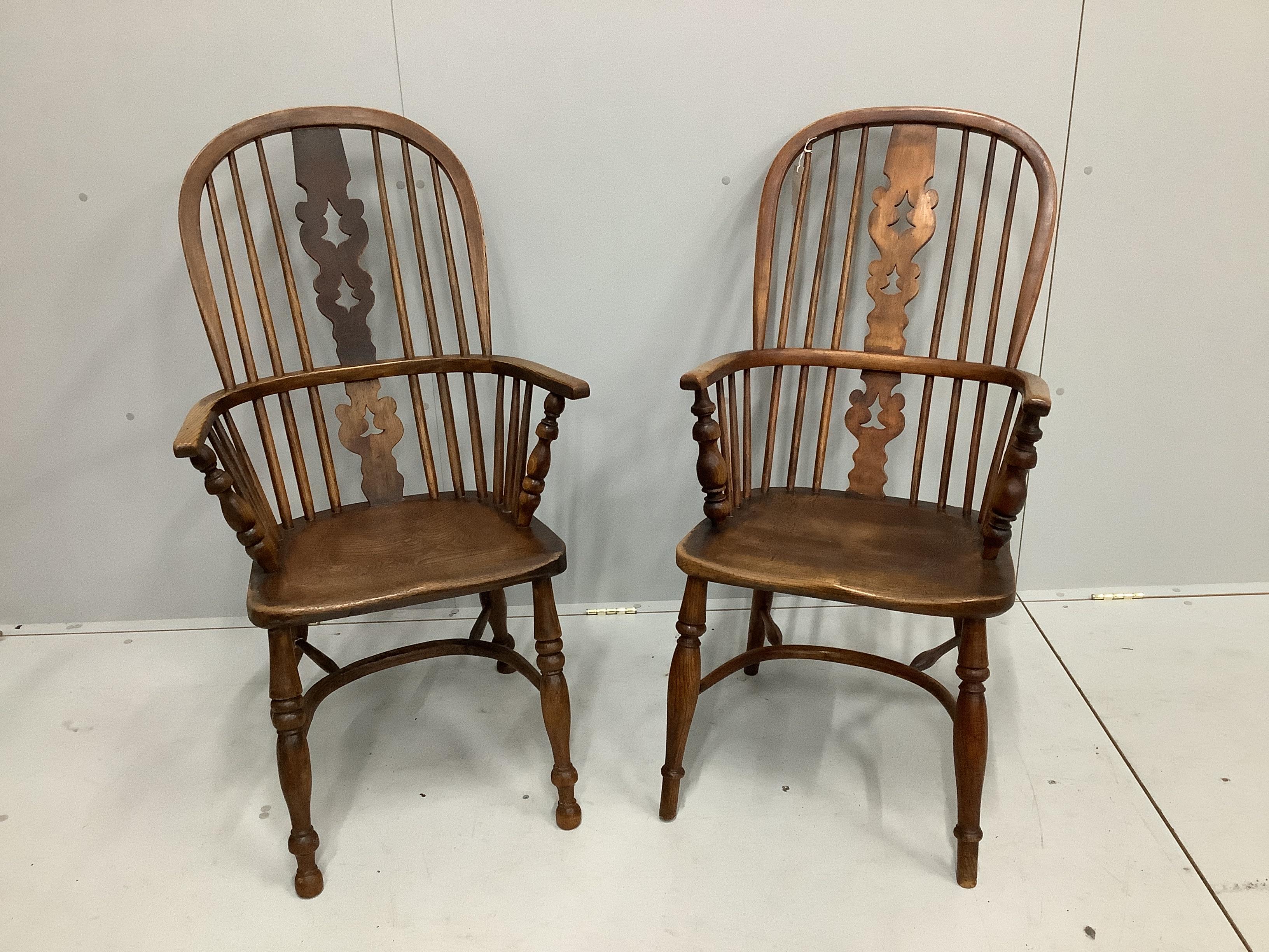 A near pair of mid 19th century Nottingham area ash and elm Windsor armchairs, larger width 53cm, depth 40cm, height 112cm